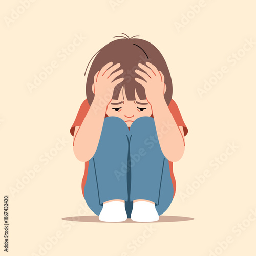 Sad child sitting on the floor with hands on head in distress  