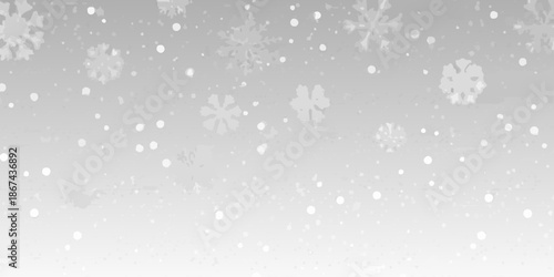 A gentle snowfall with delicate white snowflakes against a soft gray background