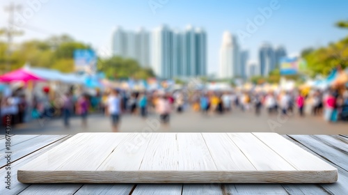 An empty wooden table and seats overlook a deserted park with a view of the Shanghai skyline, featuring iconic urban skyscrapers and business towers under a clear Asia sky