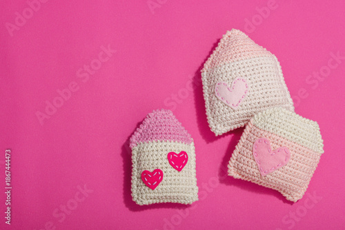 Handmade Valentines Day concept. Creative house figurines, traditional hearts, spring crocheting