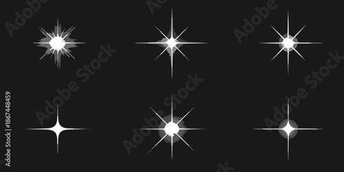 A collection of bright starbursts and sparkles on a dark background
