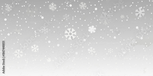 Gentle snowfall with varying sized snowflakes against a light gray background