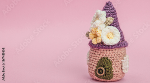 Handmade spring decor concept. Creative crocheting, house figurine, traditional flowers, decoration