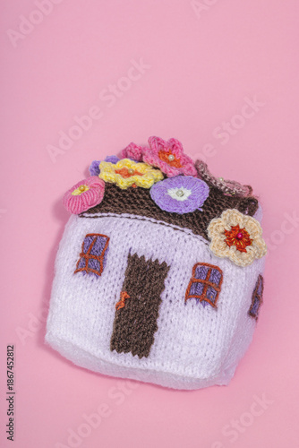 Handmade home spring decor concept. Creative crocheting, house figurine, traditional flowers