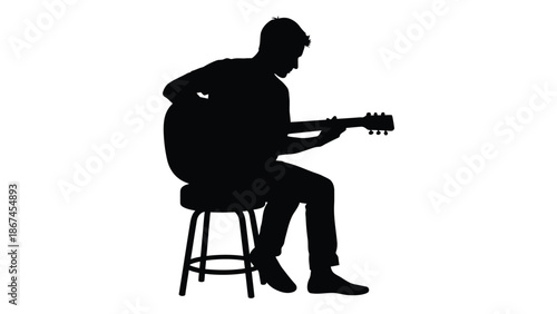 Silhouette of a man playing an acoustic guitar while seated on a stool