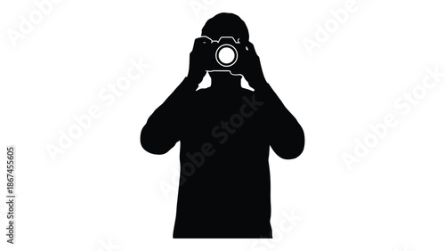 Silhouette of a photographer holding a camera up to their face