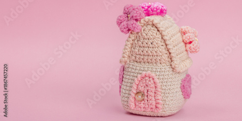 Handmade spring decor concept. Creative crocheting, house figurine, traditional flowers, decoration
