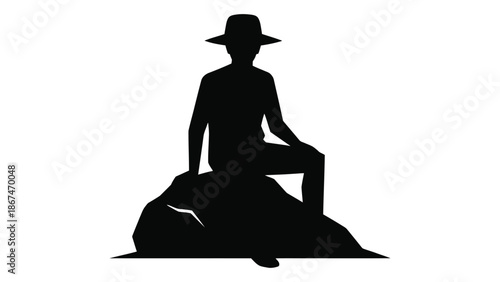Silhouette of a person wearing a hat sitting on a rock