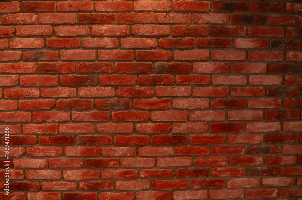 Fototapeta premium The red brick wall of the building