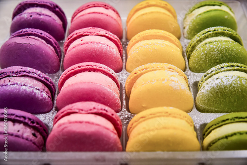 Slika na platnu Tray of colorful macarons with pink, yellow, and green flavors