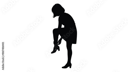 Silhouette of a woman seated and adjusting her footwear thoughtfully