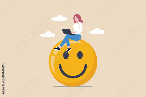 Woman working on laptop while sitting on a large cheerful smiling face
