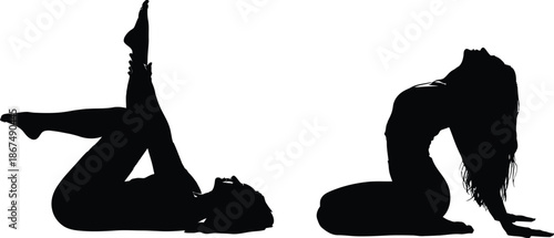 Two women in yoga poses silhouette