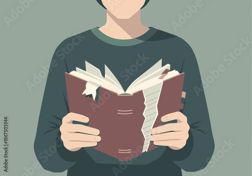 Person holding an open book with worn pages.
