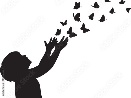 Silhouette of a person releasing black butterflies into the air hand reaching