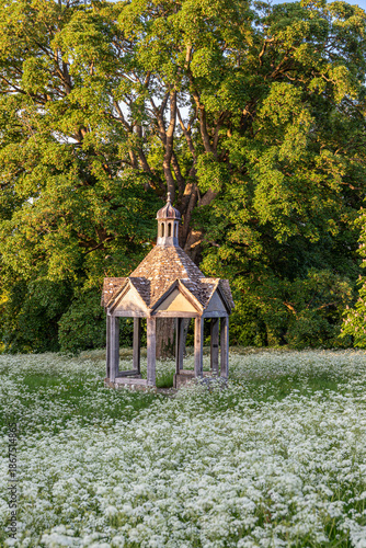 Evening light on the 1874 pumphouse on the village green of the Cotswold village of Farmington, Gloucestershire, England UK