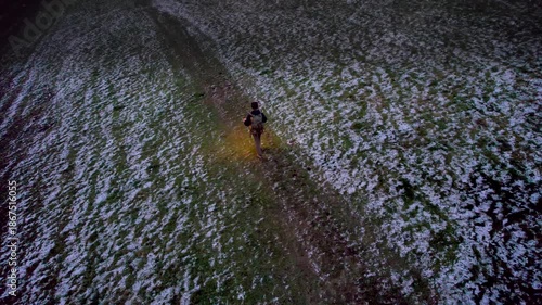 dusk Hiking Backpacker in the winter at the Cotswolds, countryside landscape, England
