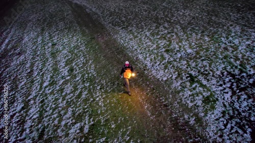 dusk Hiking Backpacker in the winter at the Cotswolds, countryside landscape, England