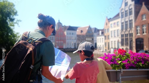 Family tourists using a map together, standing on a bridge by a canal with charming old buildings and colorful flowers, enjoying a lively summer city vacation