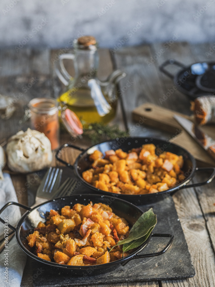 Fototapeta premium Vertical photo of two plates of migas, a traditional Spanish dish