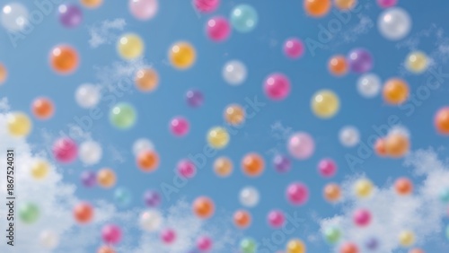 Colorful balloons floating against a blue sky with clouds. Celebration and festive event. Bright colors and cheerful atmosphere. The concept of joy and happiness.