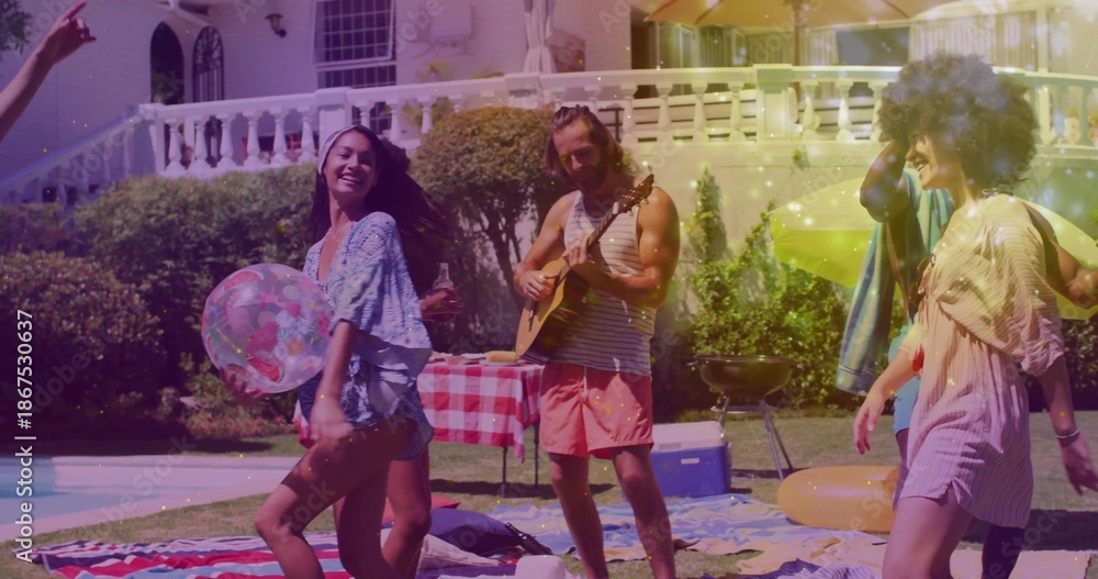 Fototapeta premium Playing man in striped tank and pink shorts strumming acoustic guitar at backyard pool with floats