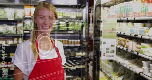 Smiling grocery employee standing in fridge aisle, red apron, glass HUD reflection, copy space