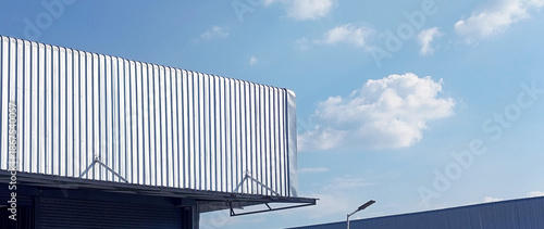 Fényképezés Metal sheet roof curve on blue sky