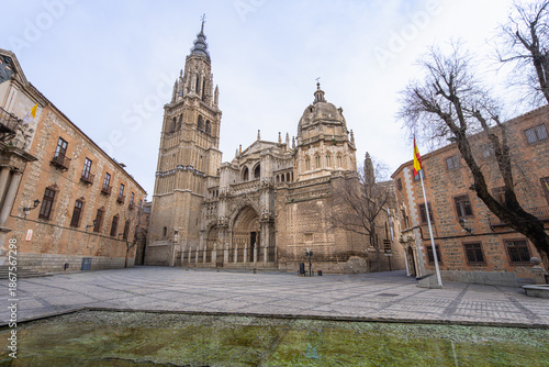 A wide view of the Toledo Cathedral with the modern water and root installation by Cristina Iglesias in the foreground square of Toledo, Spain.