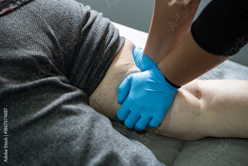 Close up of Physiotherapist working with patient on the bed stock photo