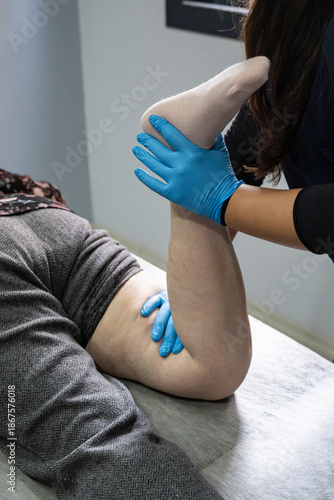 Close up of Physiotherapist working with patient on the bed stock photo