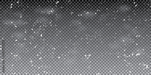 Falling snowflakes in transparent beauty, delicate and small, isolated on a clear background. 