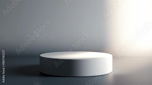Abstract motion graphic animation featuring a static cylindrical podium softly illuminated by a slow transitioning light beam across a seamless gray to white wash display, showroom, elegant