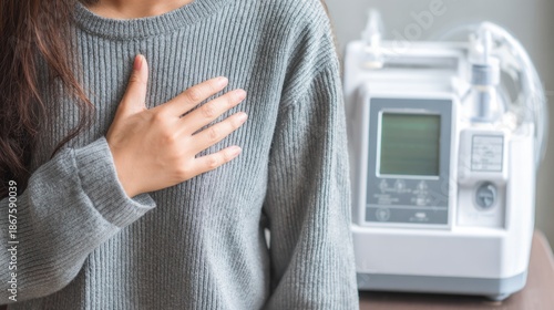 Person uses breathing device while resting at home during day in quiet room