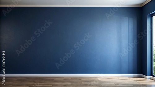 A spacious, unadorned interior showcases a dark indigo painted wall meeting white baseboards beneath a bright window.