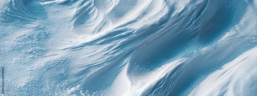 Obraz premium Pale Blue Patterns on Wind-Swept Surface Covered in Winter Snow with Textured Undulations and Gentle Curves