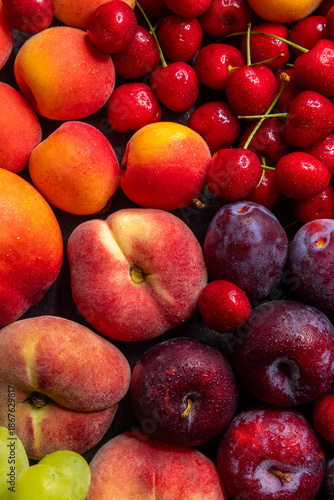 Fresh summer fruit assortment with peaches plums cherries and grapes