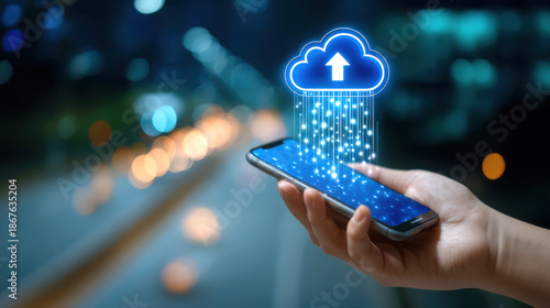 Cloud upload concept with hand holding smartphone and glowing data streaming from device