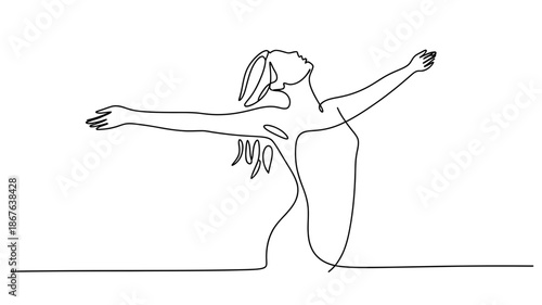 Woman with outstretched arms embracing freedom and looking towards the sky with joy
