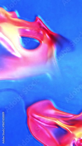 Vertical Tropical Liquid Paint Flow Abstract 4K Loop features yellow, orange, and red liquid shapes moving on a blue background in a liquid or smoke-like fashion in a vertical ratio loop.