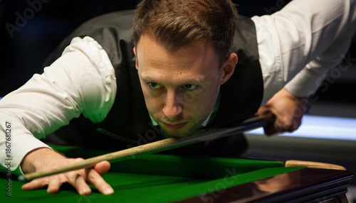 A focused player aiming to strike a cue ball on a green snooker table, showcasing concentration and skill in the game of snooker.