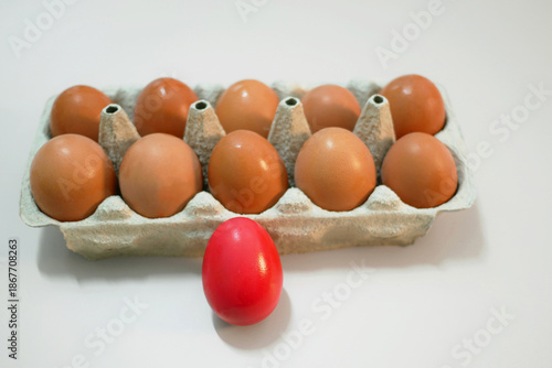 Red Dyed Easter Eggs and Natural Eggs in Carton