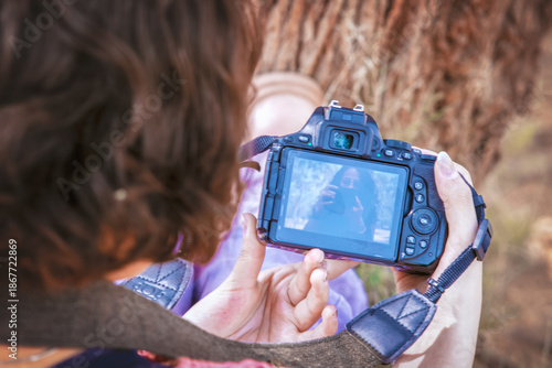 Latina teenager taking happy outdoor photos on a sunny day, perfect image to commemorate
