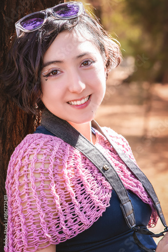 Latina teenager taking happy outdoor photos on a sunny day, perfect image to commemorate