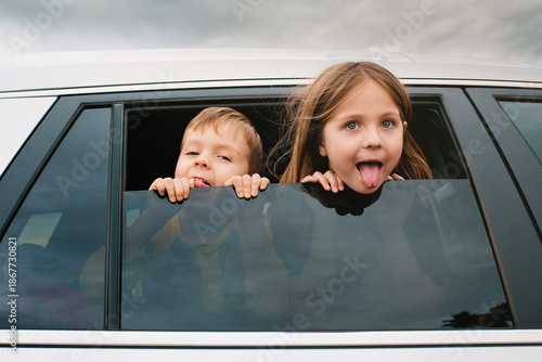 Little Boy and Girl Sticking their Heads out of the Car Window