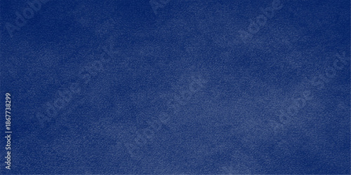 A closeup of a dark indigo blue leather and denim fabric texture shows a rough macro pattern on the cloth material surface for a fashion design backdrop