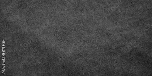 A dark vintage backdrop featuring a rough black leather and fabric texture with a grunge pattern on a blank gray surface for a textured wallpaper design