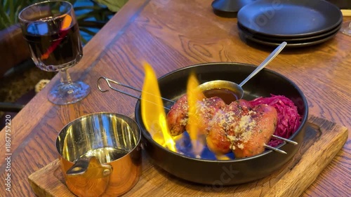 sausages on the fire Super slow-motion close-up of sausages grilling on a black grill, flame coming out from the stove
