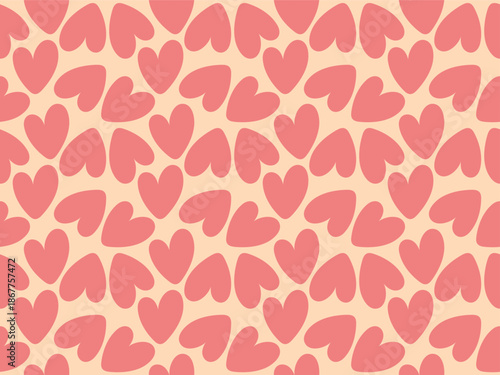 Seamless pattern with soft rounded heart shapes in warm pink tones on light peach background. Minimal romantic design creates cozy mood for wrapping paper, fabric, wallpaper, stationery and packaging.
