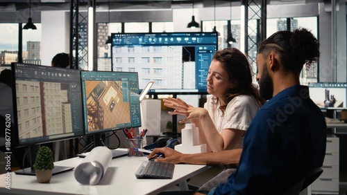 Tableau sur toile Engineer and property developer working with architectural design software, analyzing project layouts and renovation strategies for real estate expansion and urban development
